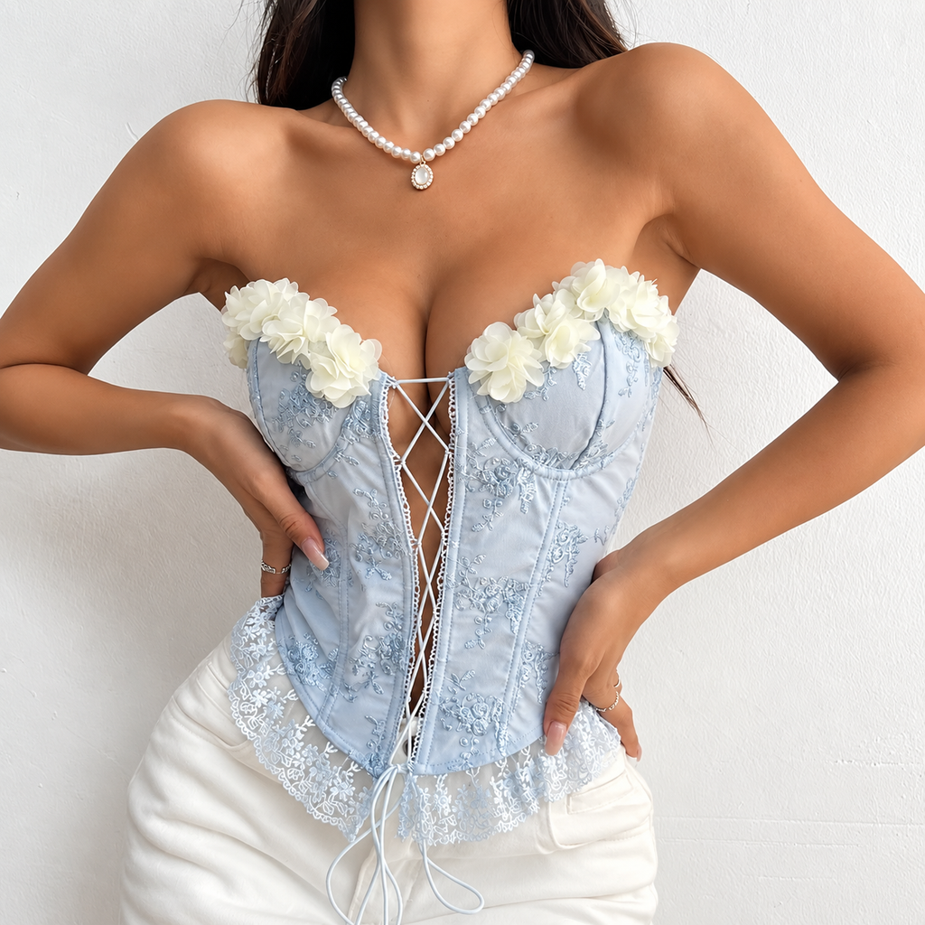 Powder blue floral corset top with white 3D flowers, sculpted cups and lace-up front, full front view