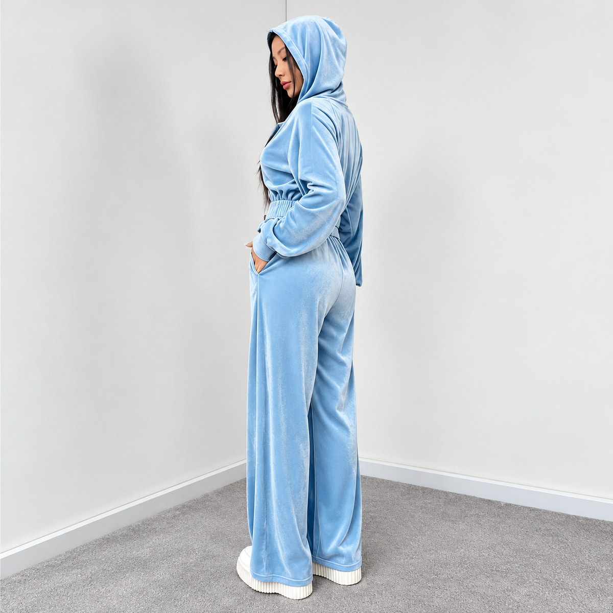 Light blue velour tracksuit side view with hooded cropped jacket, elastic waist and wide-leg pants