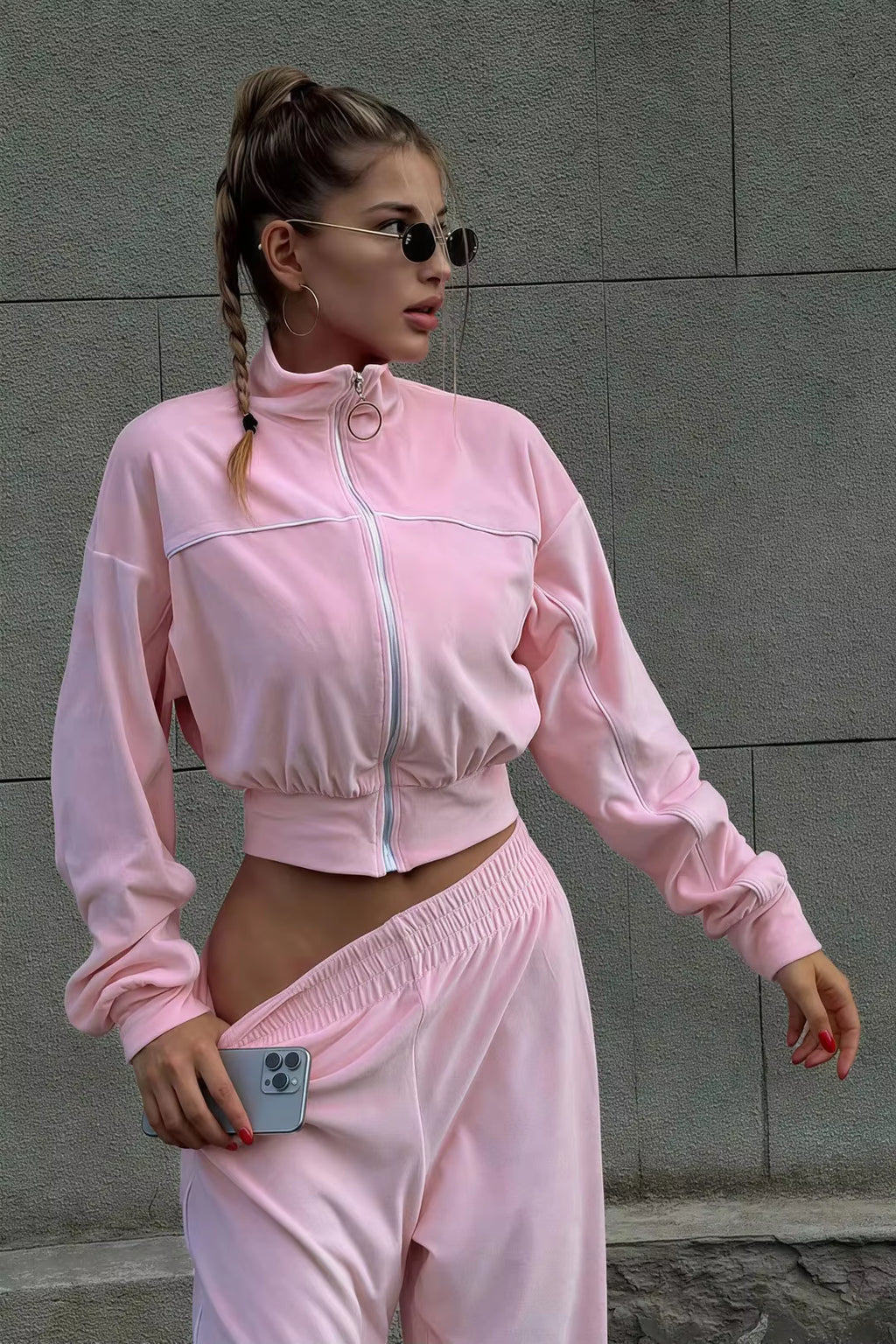 Pink zip track jacket close-up with high collar, ring zipper and white contrast piping