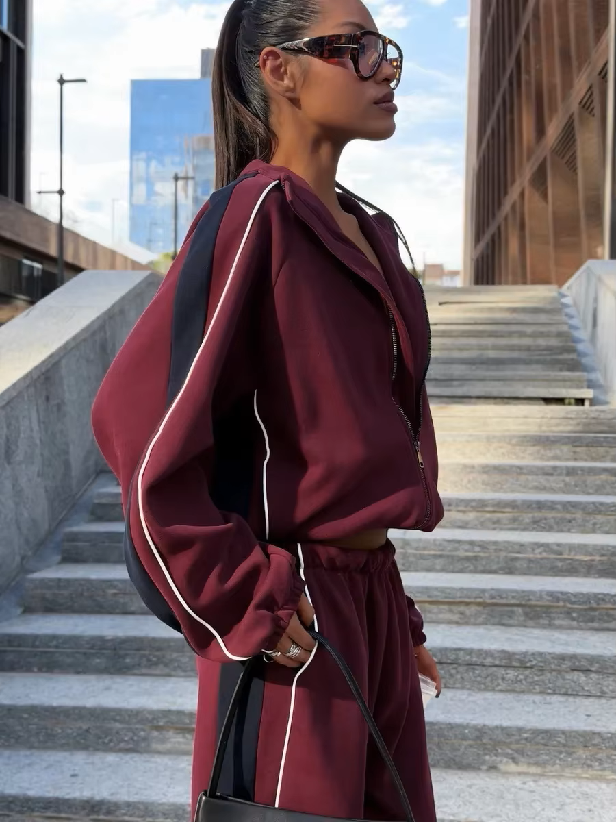 Burgundy and navy track jacket set close-up showing contrast piping, elastic waist and relaxed fit