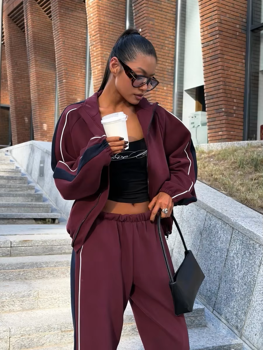 Burgundy and navy track jacket set close-up showing contrast piping, elastic waist and relaxed fit