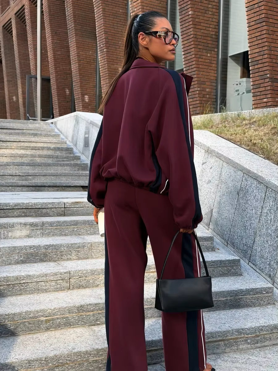 Back View Burgundy contrast stripe tracksuit with navy sleeve panels, zip track jacket and wide-leg pants