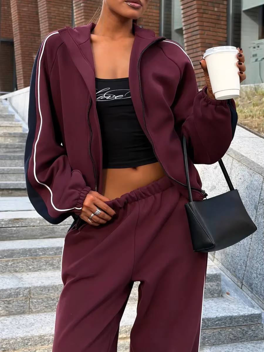 Burgundy and navy track jacket set close-up showing contrast piping, elastic waist and relaxed fit