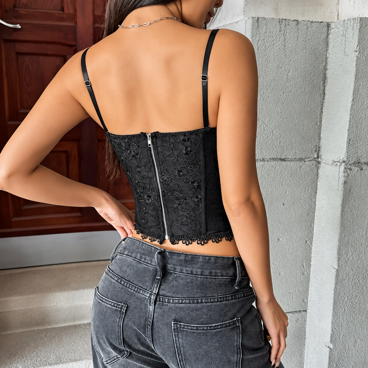 Back view of floral lace corset top showing adjustable shoulder straps and center back zipper