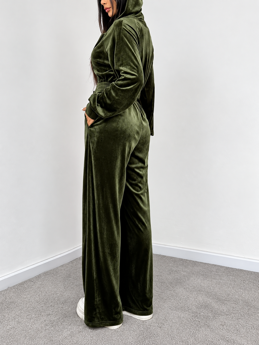 Olive velour hoodie and wide-leg pants set side view showing relaxed fit, hood and side pockets