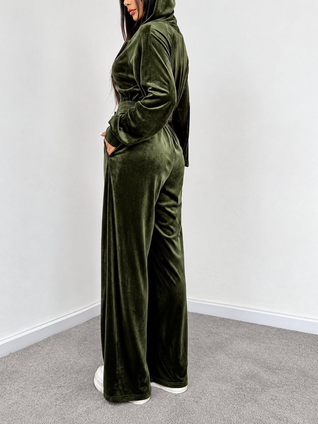 Olive velour hoodie and wide-leg pants set side view showing relaxed fit, hood and side pockets