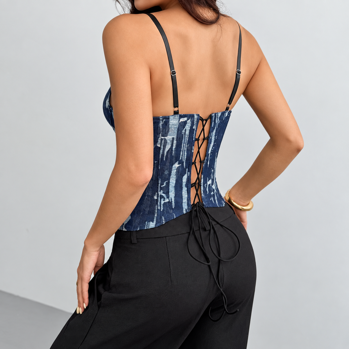 Back view of lace panel corset top with adjustable straps and lace-up closure