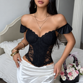 Black lace ruffle corset top styled off shoulder with a white satin skirt, front view