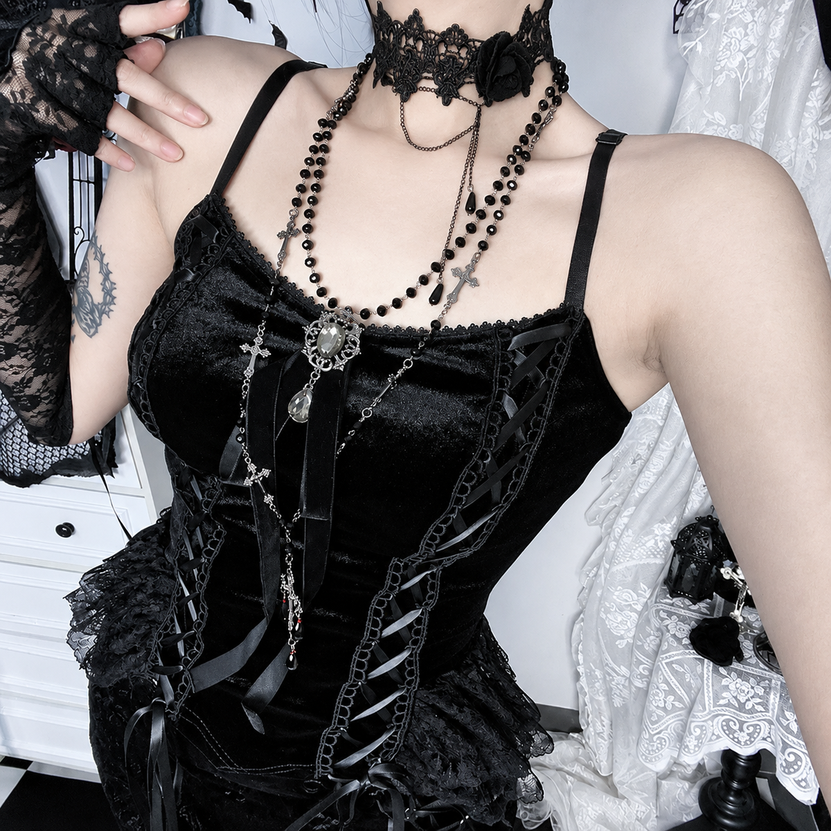 Black velvet corset top with fitted camisole silhouette and gothic lace detailing