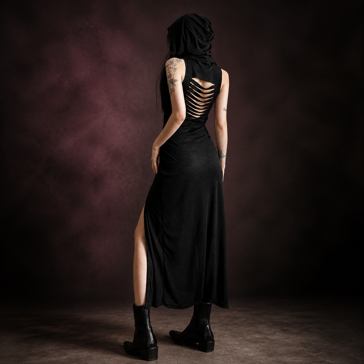 Back view of black hooded maxi dress with horizontal cutout detail