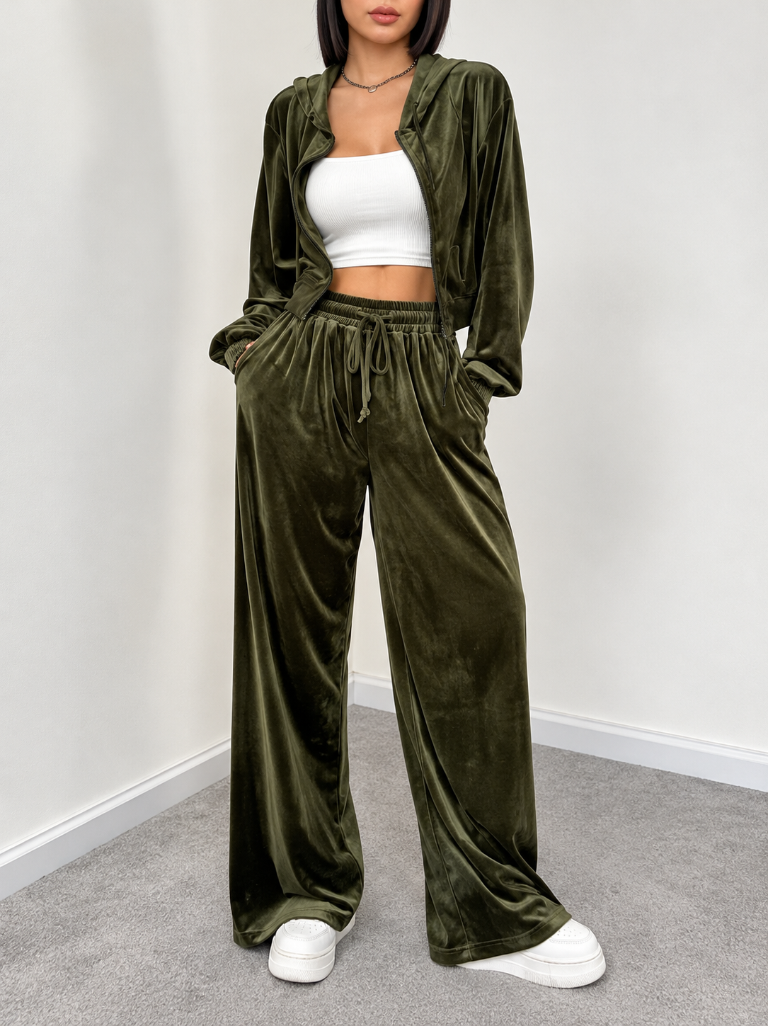 Olive velour cropped zip hoodie and wide-leg pants styled open over a white crop top