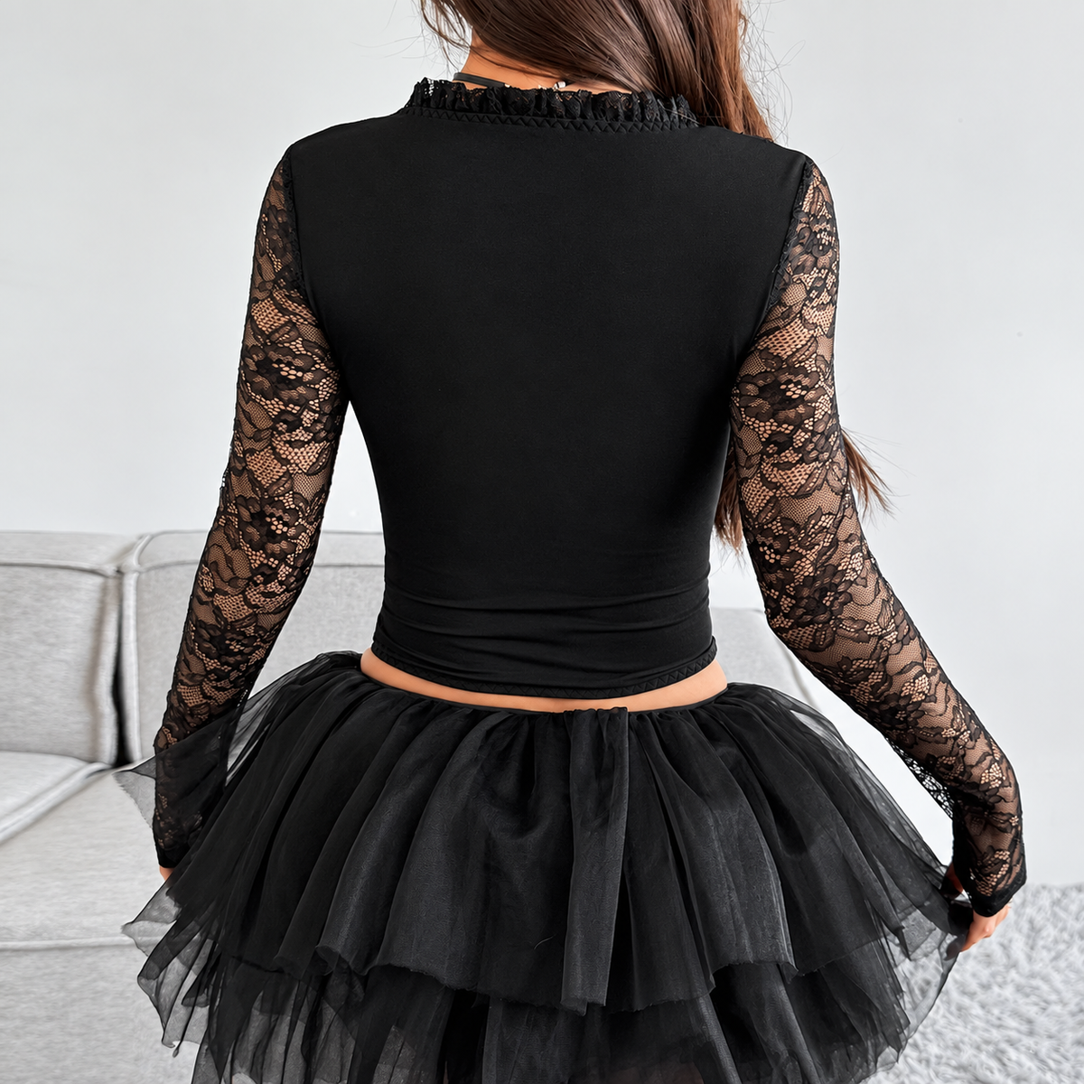 Back view of gothic corset top showing solid fitted back and long sheer floral lace sleeves
