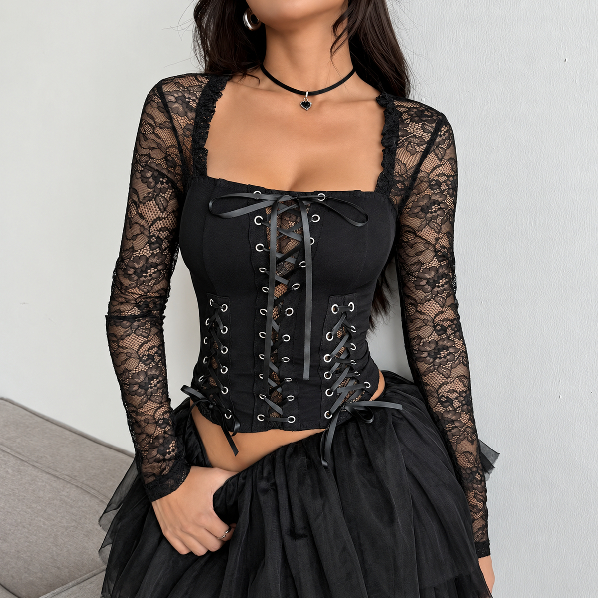 Gothic floral lace corset top with long sleeves and multi-panel front lacing styled with a tulle skirt