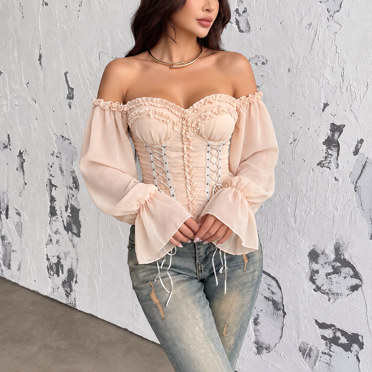 Front view of champagne ruched corset top with sweetheart neckline, long sheer sleeves and decorative lacing