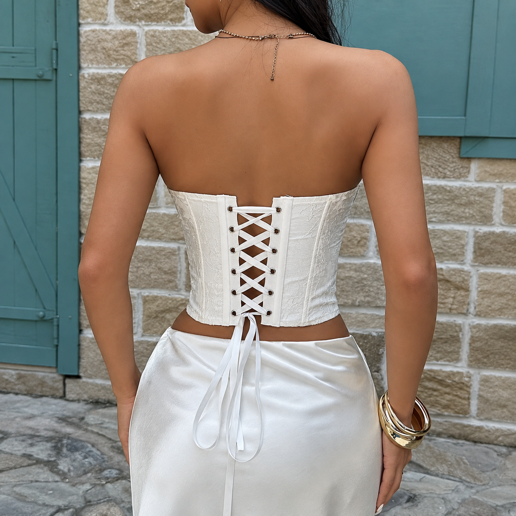 Back view of white floral corset top with ribbon lace-up closure and fitted longline silhouette