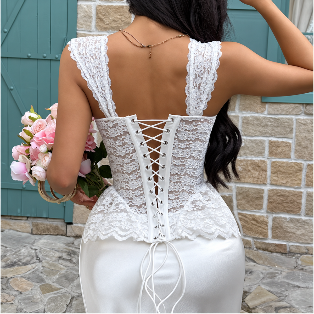 Back view of white lace corset top with wide lace straps and adjustable lace-up back closure