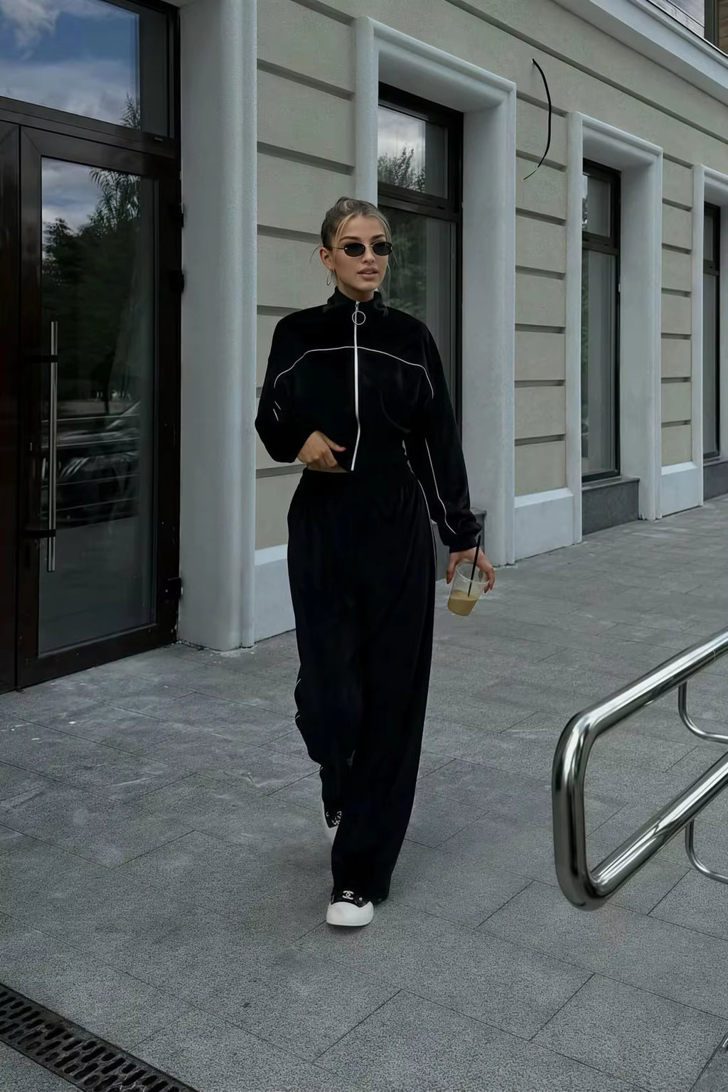 Black cropped track jacket and relaxed wide-leg pants styled as a sporty streetwear outfit
