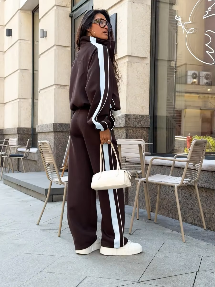 Chocolate brown contrast stripe tracksuit side view with relaxed zip jacket and wide-leg pants