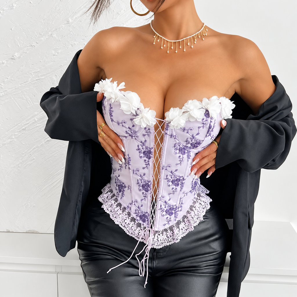 Lilac floral corset top with white 3D flowers and lace-up front styled with a black jacket and leather pants