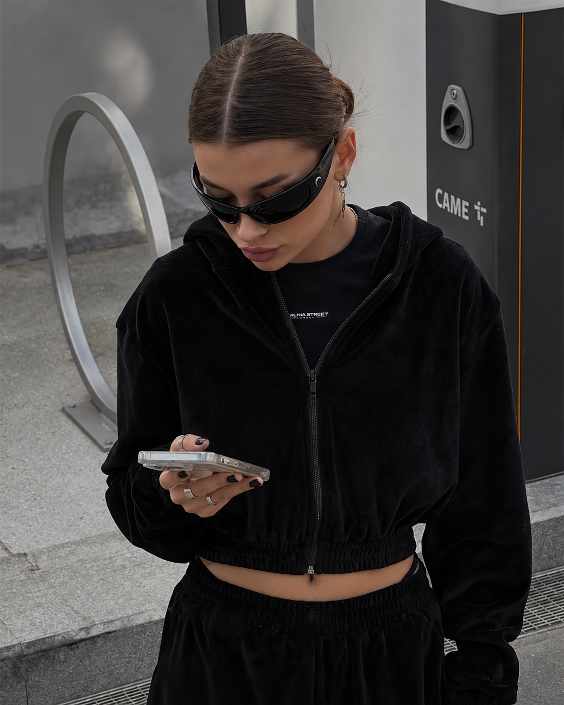 Black cropped zip hoodie tracksuit close-up showing soft polyester fabric, hood and elasticated hem