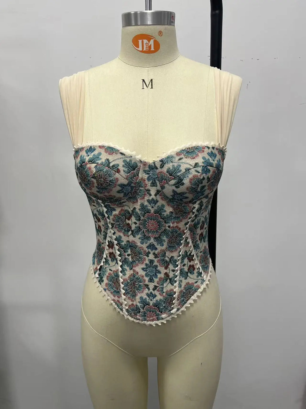 Floral tapestry corset top with fitted corset silhouette and wide cream straps