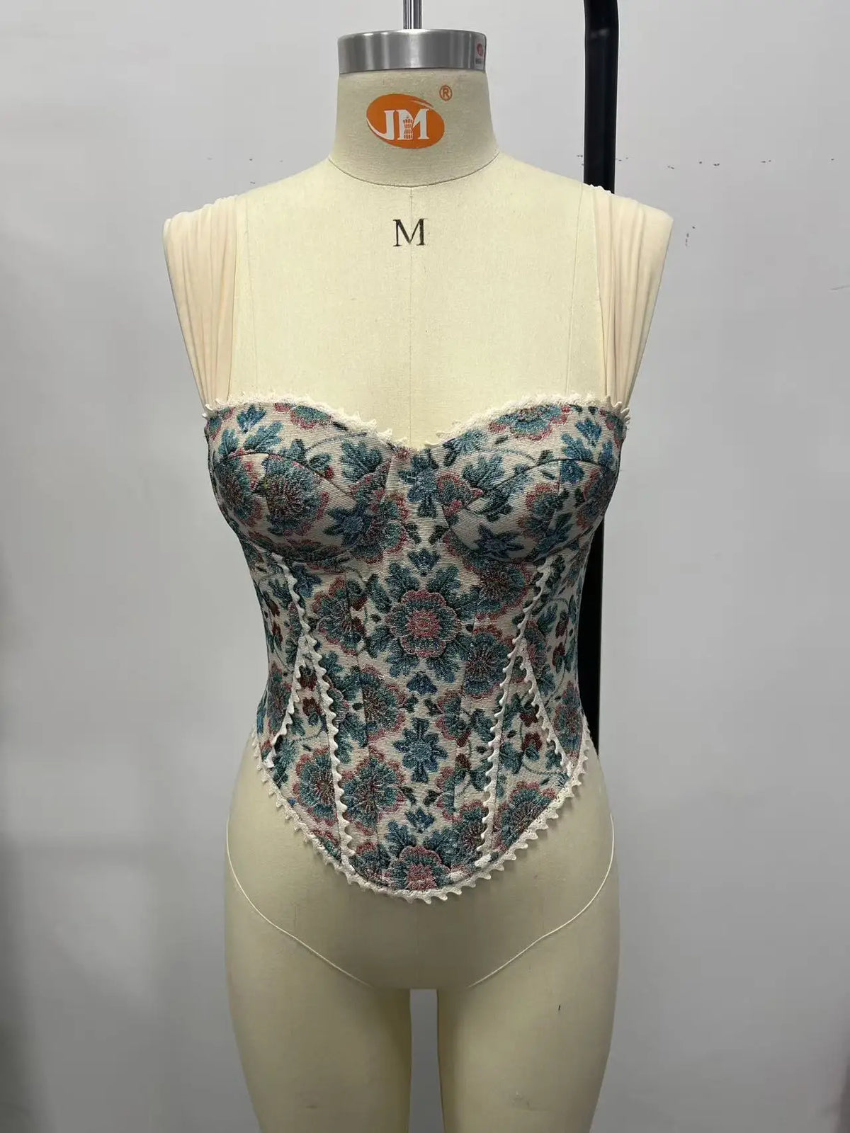 Floral tapestry corset top with fitted corset silhouette and wide cream straps